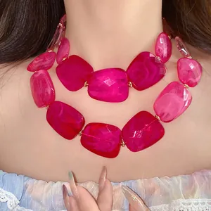 Close-up detail of a vibrant pink irregular acrylic double-layer statement necklace