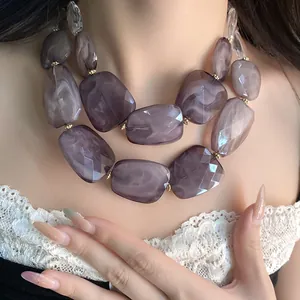 Close-up detail of double-layer necklace with irregular purple faceted acrylic beads