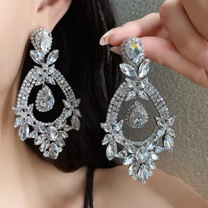 Macro view of vintage court style teardrop earrings with sparkling clear crystals.