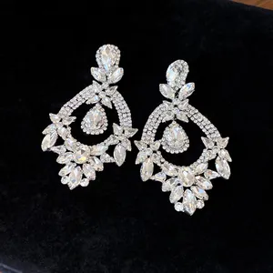 Close-up of elegant crystal chandelier earrings with floral and water drop designs
