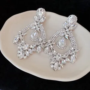 Detailed macro view of luxurious vintage-style teardrop earrings featuring sparkling rhinestones