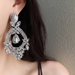 Detailed macro view of sparkling silver waterdrop earrings with floral rhinestone pattern