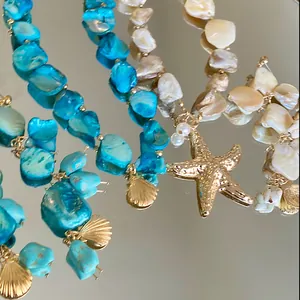 Irregular shell and pearl necklace with gold starfish and shell pendants for summer.