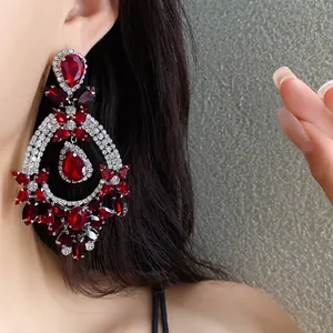 Vintage silver needle red crystal teardrop earrings with rhinestone details on model