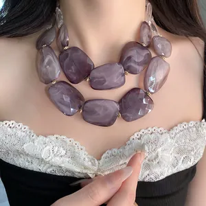 Detailed shot of double-layered purple marble acrylic beaded necklace worn on model