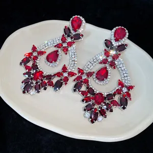 Detailed macro view of luxury palace-style earrings with red waterdrop crystals