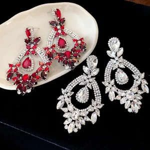 Detail view of vintage crystal drop earrings in red and clear rhinestones.