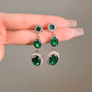 Vintage emerald green oval drop earrings with silver needle for elegant court style.