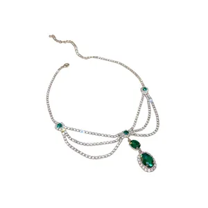 Elegant palace style necklace with green oval gemstones and sparkling rhinestones.