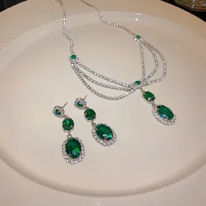 Detailed view of elegant green gemstone necklace and earring set in vintage court style