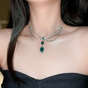 Close-up of vintage royal style emerald green tassel necklace on a female model neck