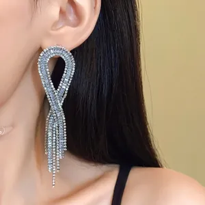 Elegant geometric tassel earrings with zircon inlay on silver needles shown on model