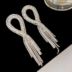 Close-up of silver-plated tassel earrings with sparkling cubic zirconia crystals detail