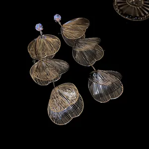 Close-up of elegant floral tassel earrings with sparkling rhinestones and filigree petals