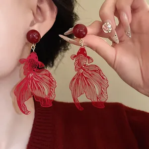 Detailed view of red hollow-out goldfish clip-on earrings in elegant Chinese style