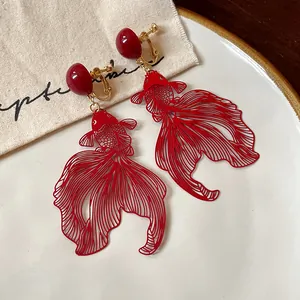 Macro detail of red koi goldfish hollow-out dangle earrings for non-pierced ears