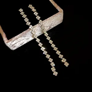 Detailed view of elegant long tassel earrings featuring sparkling square rhinestones