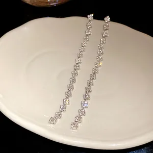 Exquisite silver needle tassel drop earrings with sparkling square rhinestones on dish