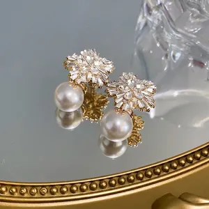Elegant S925 silver needle earrings with sparkling diamond flowers and white pearls