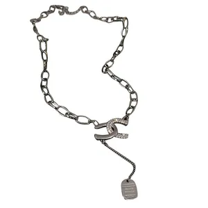 Silver chain necklace with crystal-encrusted double C interlocking pendant design.