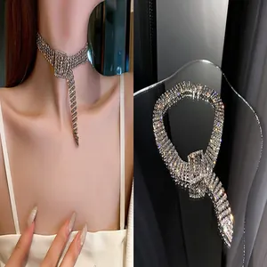 Detailed view of a glittering rhinestone buckle choker necklace on model and surface.