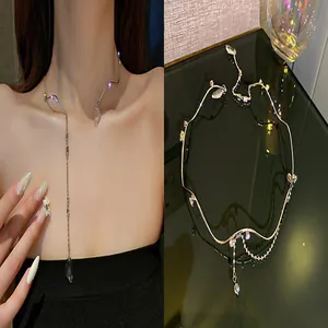 Elegant asymmetrical silver necklace featuring sparkling rhinestones and a chic drop pendant