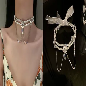 Elegant double-layered pearl choker necklace featuring rhinestone flower and tassel detail