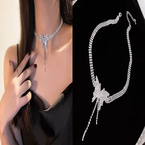 Detailed view of elegant silver butterfly rhinestone choker on model and black background.