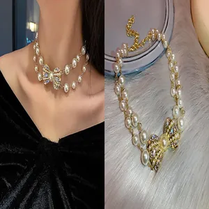 Detailed view of elegant double-layer pearl necklace with sparkling rhinestone bow