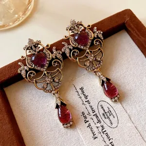 Exquisite vintage gold earrings with heart and teardrop purple stones and crystals
