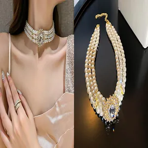 Detail showing 3-row pearl choker necklace with a large sparkling rhinestone centerpiece