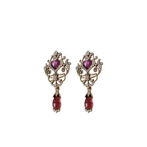 Vintage gold-tone hollow earrings with purple heart and teardrop gemstones, elegant style