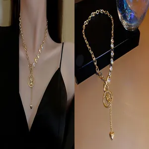 Detail of gold coin and heart pendant necklace with crystal accents