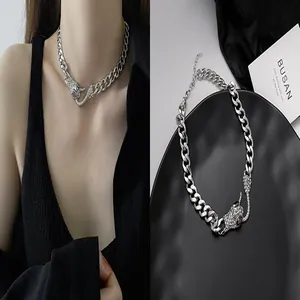 Detailed view of a silver cuban link necklace with a sparkling bull head pendant