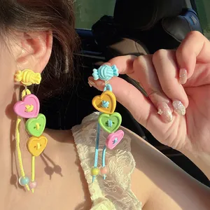 Detailed view of vibrant Dopamine style heart button tassel earrings in colorful candy design