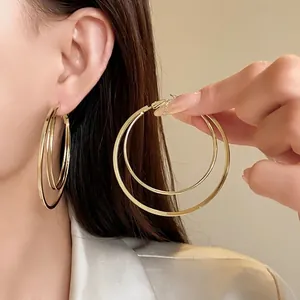 Large gold multi-layer hoop earrings with steel needles for a minimalist fashion look