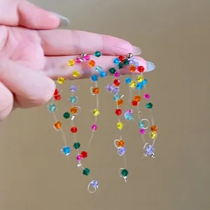 Close-up view of colorful crystal beaded tassel earrings featuring a vibrant dopamine style