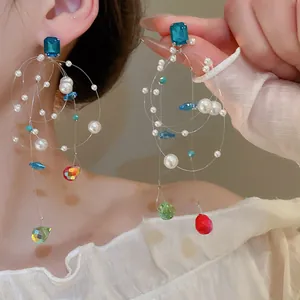 Detailed view of colorful dopamine tassel earrings with pearls and crystal droplets