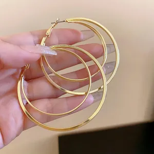 Detail showing the layered structure of elegant gold hoop earrings with steel needles
