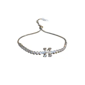 Minimalist silver tennis bracelet featuring clear zircons and a central H-letter charm