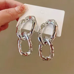 Irregular metallic oval linked earrings with high-shine silver finish and minimalist design
