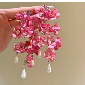 Elegant pink fabric flower tassel earrings with white teardrop pearl accents, silver studs.