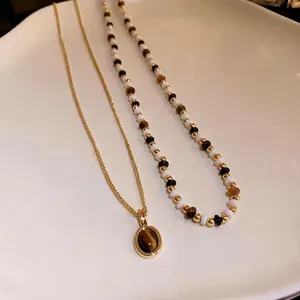 Elegante set di collane vintage placcate in oro con ciondolo occhio di tigre e perline