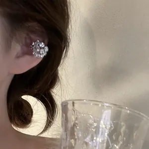 Close-up detail showing a sparkling micro-pave crystal ear cuff for non-pierced ears