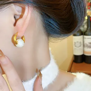 Detailed macro view of French retro 18k gold plated hoop earrings with textured pearl bead