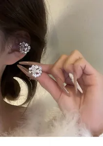 Detailed view of micro-paved sparkling diamond ear cuffs for non-pierced ears