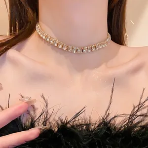 Elegant gold-tone double-row rhinestone tennis necklace choker as seen on model wearing feathers