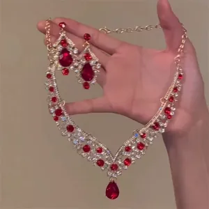 Luxurious vintage gold-tone jewelry set featuring red teardrop zircon necklace and earrings