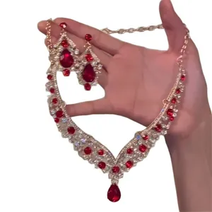 Elegant vintage gold-tone jewelry set with red teardrop stones and sparkling clear crystals