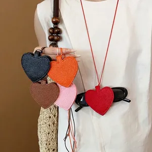 Stylish heart-shaped pebbled leather sunglasses holder necklace shown in vibrant color options